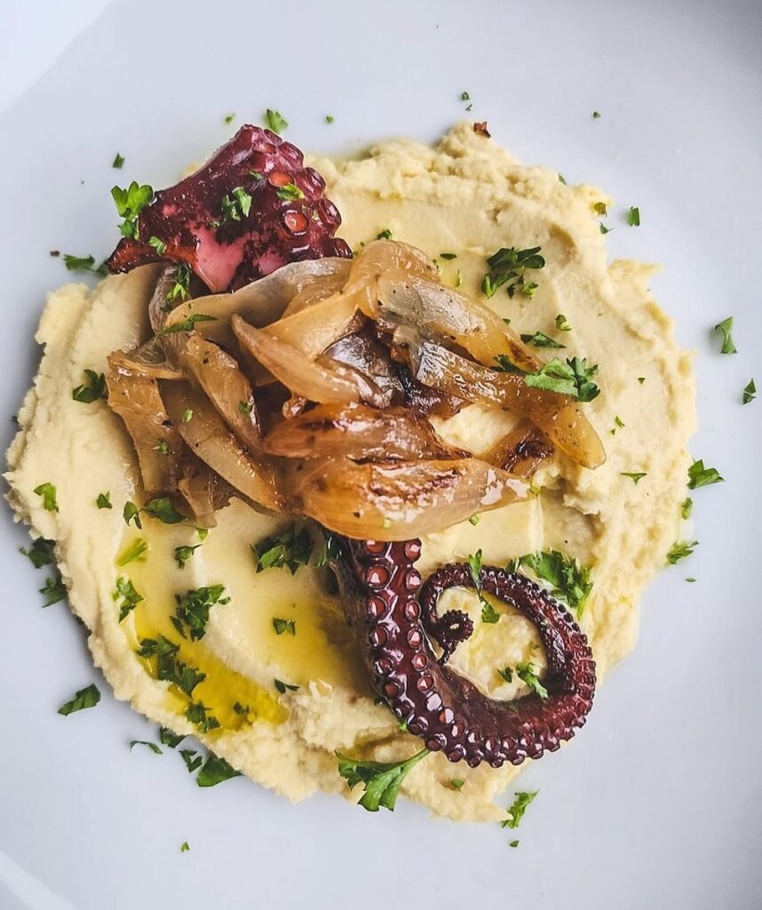 A plate of seafood in hummus and oil from Anthos.