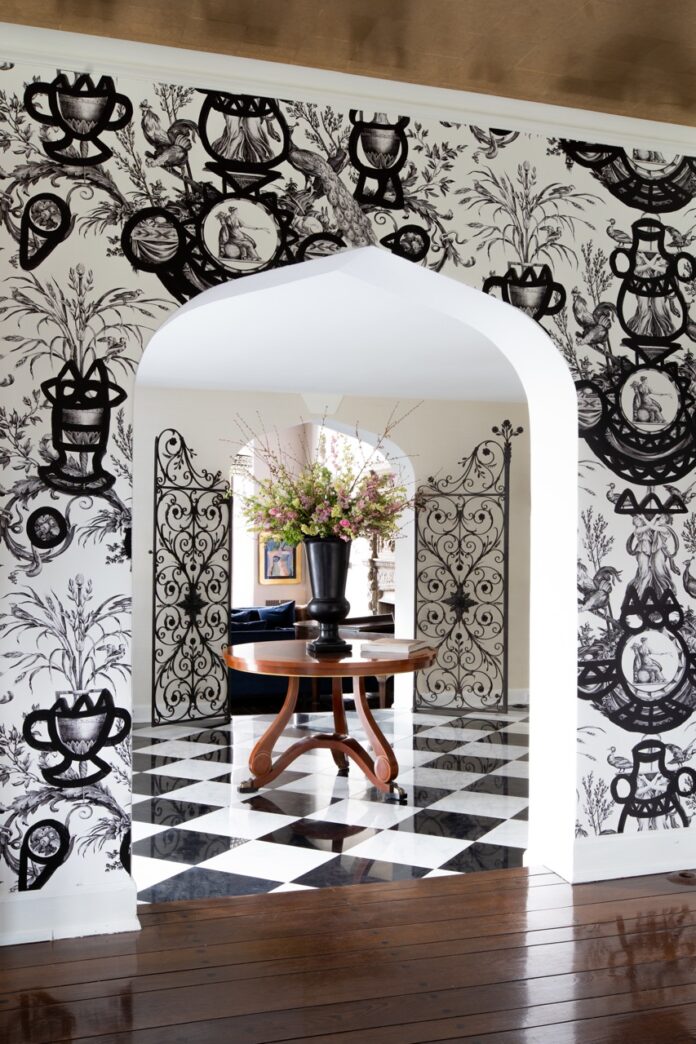 A black and white pattern archway leads into a checkerboard design floor.