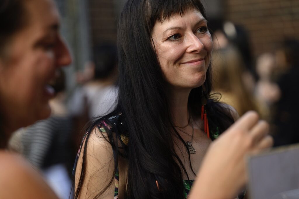 A woman with dark long hair and bangs.
