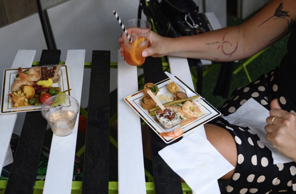 A person dines on seafood boil at a design launch party.