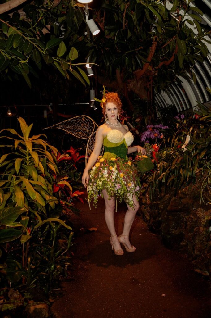 A woman in a pixie costume in a garden.