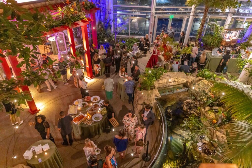 People throughout a party at a garden center.