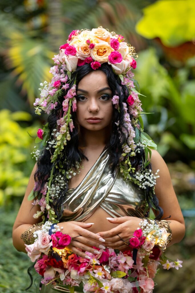 A woman in a band top and florals all through her hair.