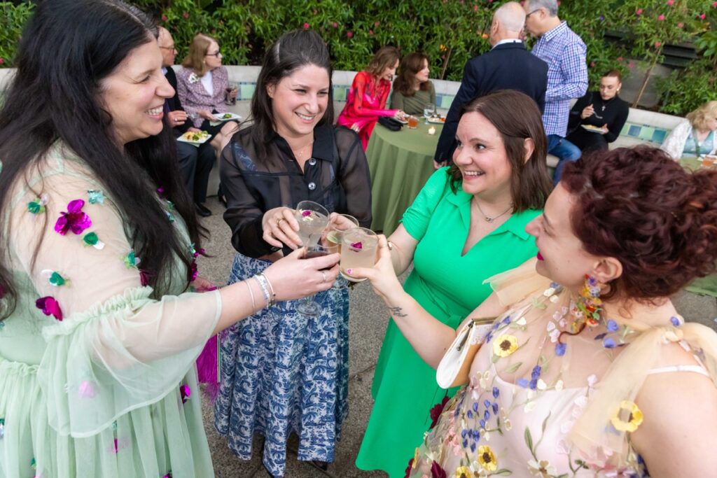 A group of women cheers their cocktails.