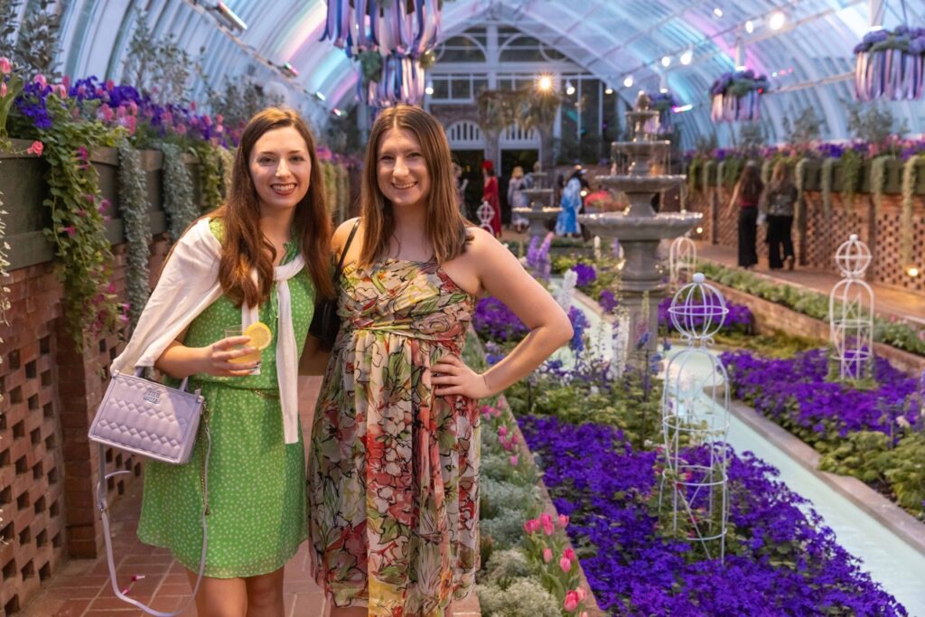 Two guests enjoy the gorgeous florals at Phipps.