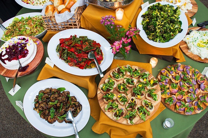 Various big food plates of Mediterranean recipes.