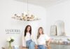 La Storia Design Company Brings a New Store to Shadyside Two women in white lean and sit on the La Storia counter.