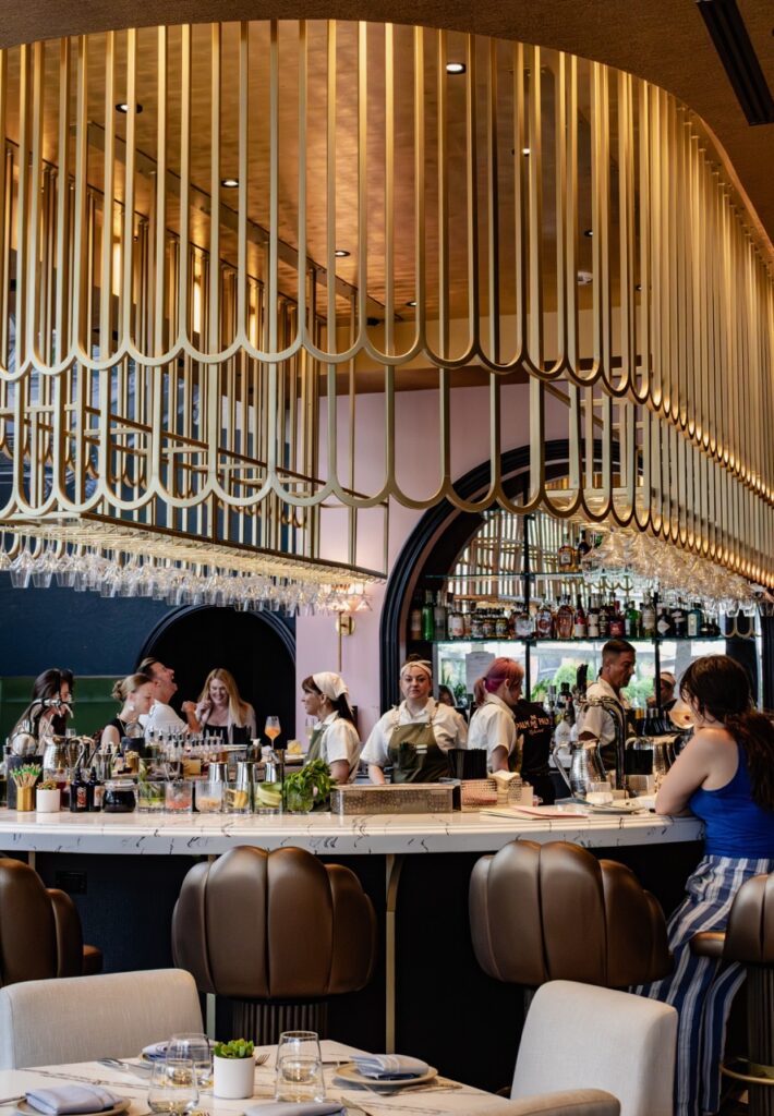 A horseshoe stay bar with gold scalloped cages above it.