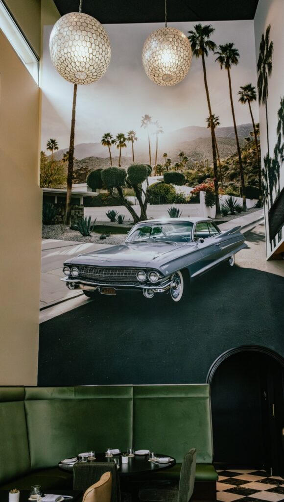A wall of Palm Palm restaurant with a large mural of a vintage car.