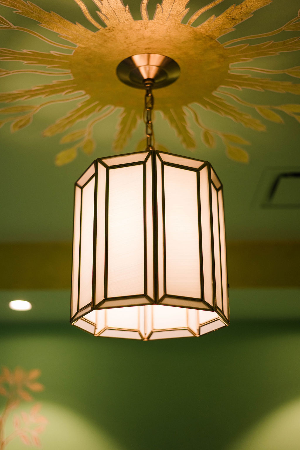A gold spot painted to come from a ceiling light.