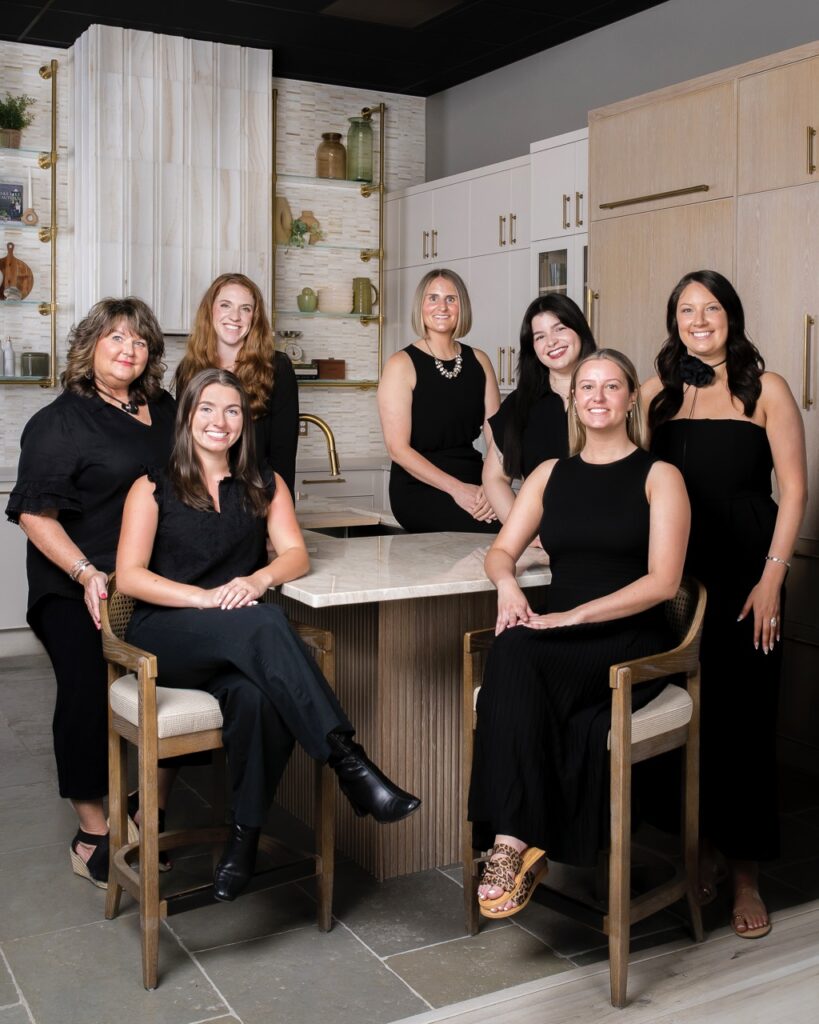 A group of women designers at SPLASH showrooms sits at a kitchen table.