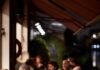 London Restaurants to Add to Your Itinerary The inside of Towpath in London with a group of people sitting at a dining table.