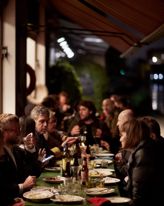 The inside of Towpath in London with a group of people sitting at a dining table.