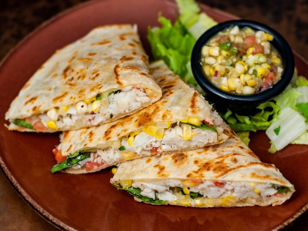 Three tacos from Mad Mex with a delicious side.