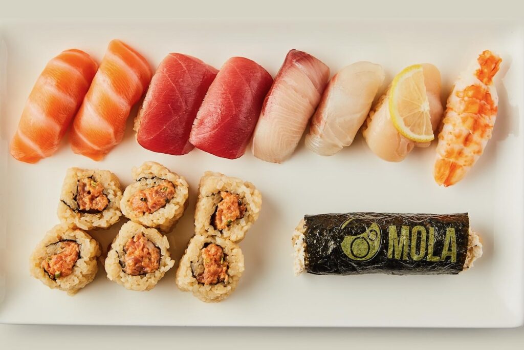 A plate of sashimi on a white plate from Mola.