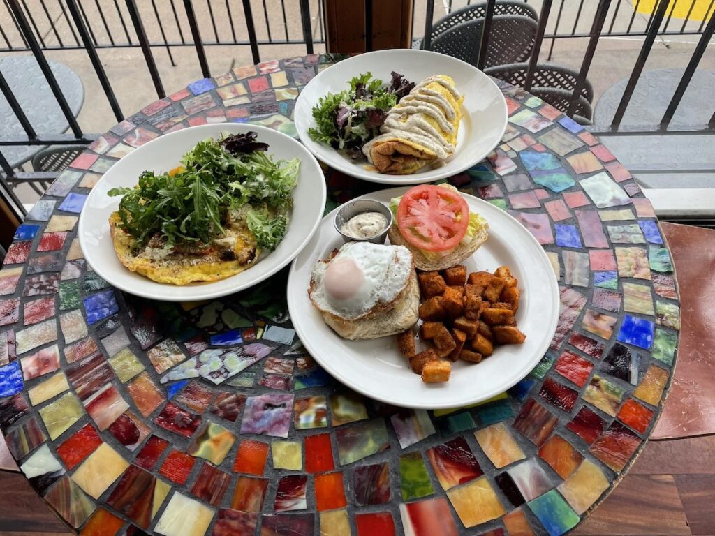A tiled tabletop with three plats on it
