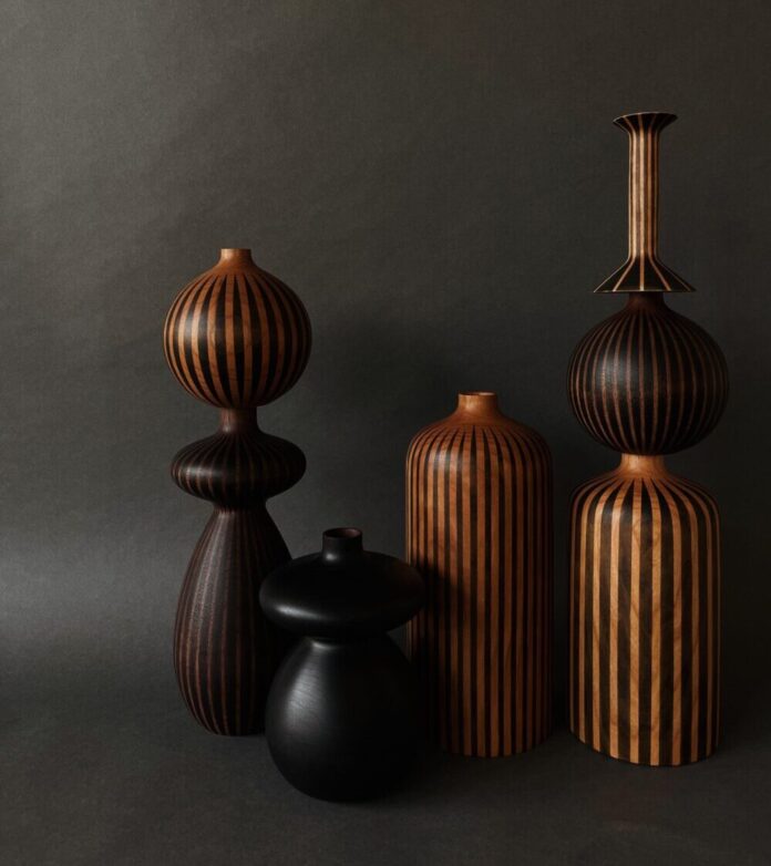 A collection of vases and candleholders made of ebonized cherry and walnut.