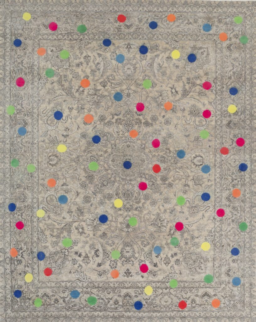 A classic grey looking rug with rainbow polka dots on top.