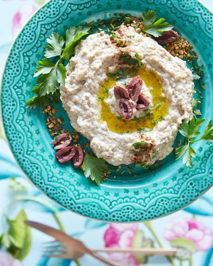 An above shot of a turquoise bowl filled with Baba Ghanouj.