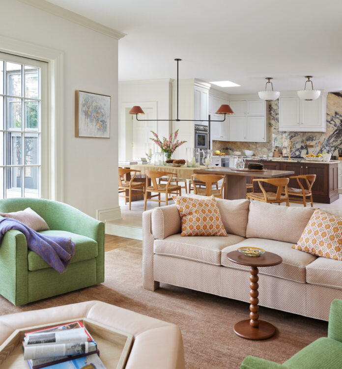 living room with creme couch and green chairs with double shade hanging light fixture