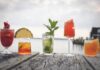 Bartenders Share Their Go-To Summer Sips in a Heat Wave A dock of various fruit cocktails with extravagant garnishes.