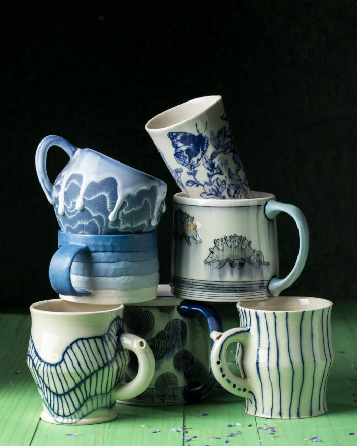 A collection of mugs by many of the artists in CRAFTED!