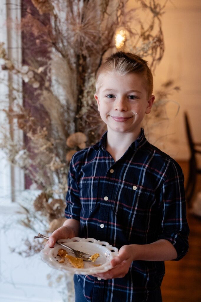 A little boy with a plate of Friendsgiving food.