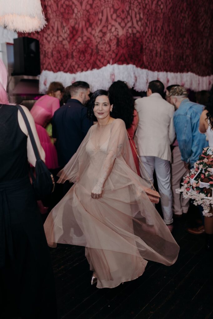 A woman in a long veiled white dress in the crowd.