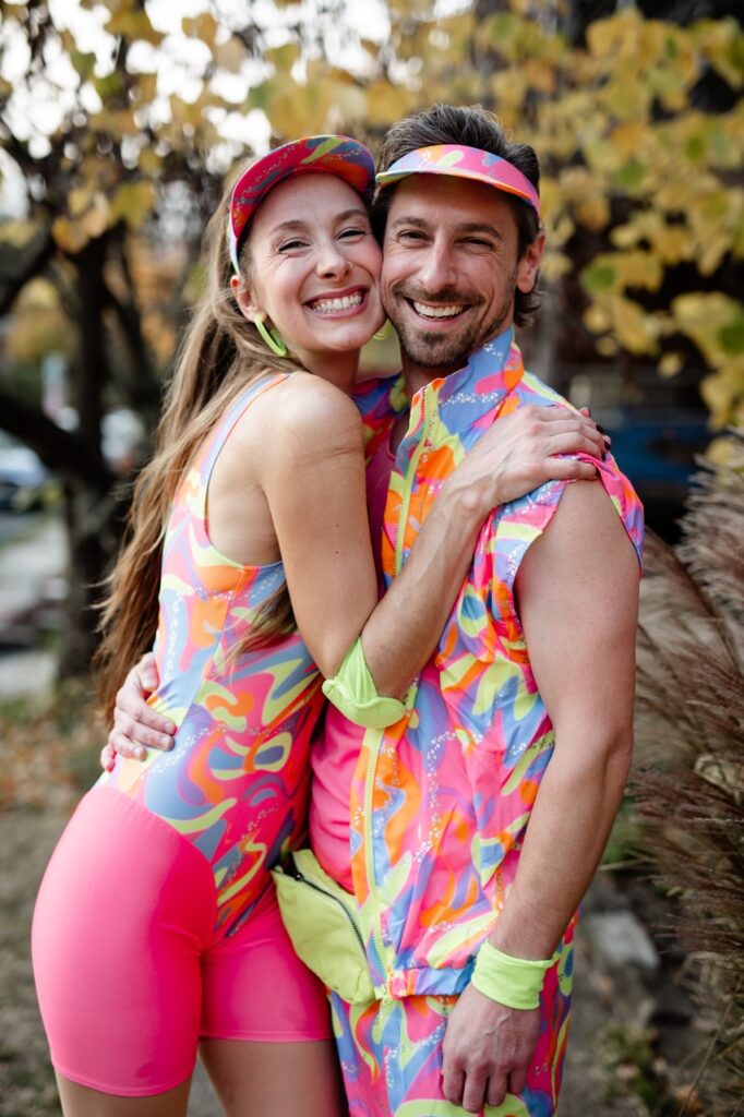 A man and woman in roller skating Barbie and Ken outfits.