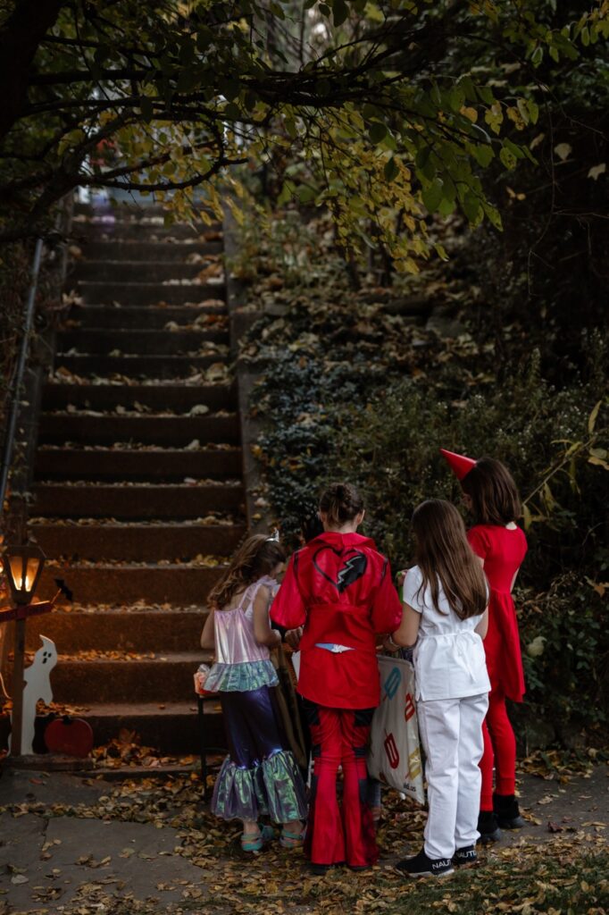 A group of children gather at the bottom of an outdoor staircase.