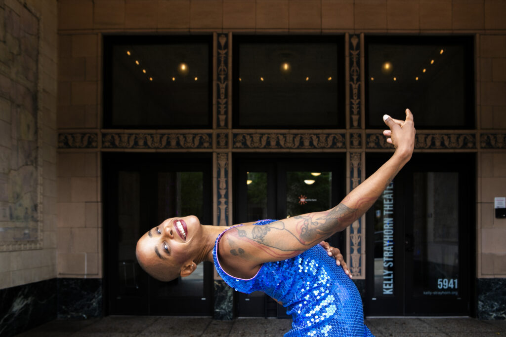 Jasmine Hearn leans back outside of a theater.