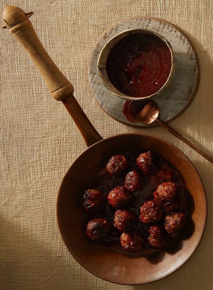 Flavorful meatballs in cranberry gojuchang sauce, creating a harmonious blend of sweet, savory, and spicy flavors, perfect for a satisfying and delicious meal.