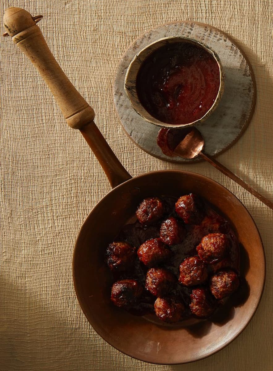 Flavorful meatballs in cranberry gojuchang sauce, creating a harmonious blend of sweet, savory, and spicy flavors, perfect for a satisfying and delicious meal.