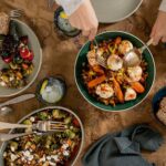 Roasted Brussels Sprouts with Romesco Sauce & Aged Feta served in a bowl.