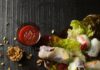 Spring Rolls with Asian Pear Dipping Sauce A flat lay of fresh spring rolls with a sweet potato noodle filling, arranged on lettuce leaves with a side of dipping sauce and roasted peanuts.