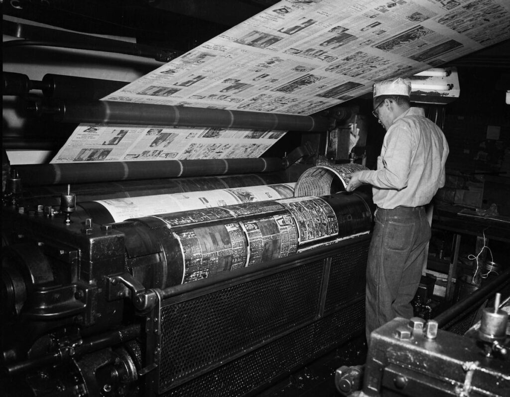 Charles "Teenie" Harris works on the printing press of the Pittsburgh Courier.