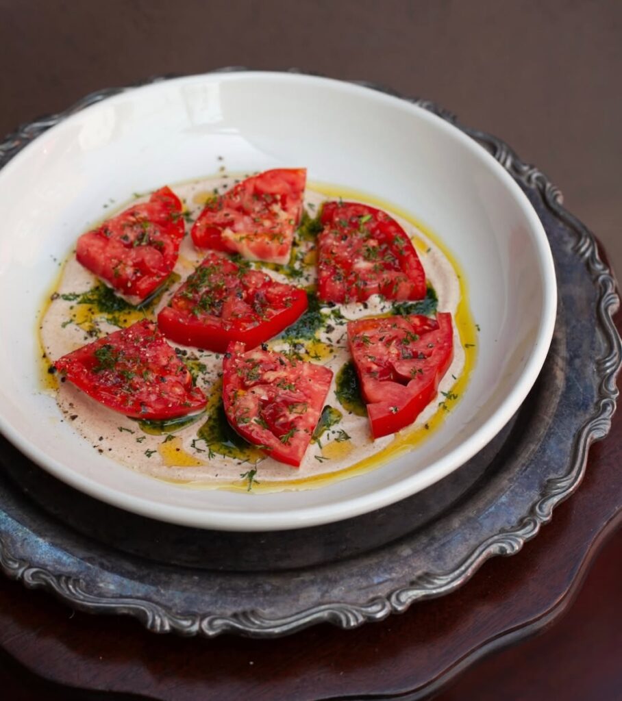 A plate of tomatoes from Fet-Fisk for a summer menu update.