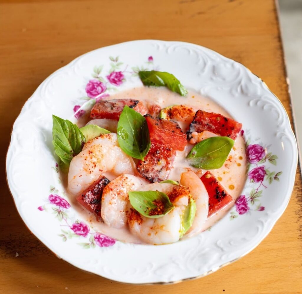 A plate of ceviche on a tan background.