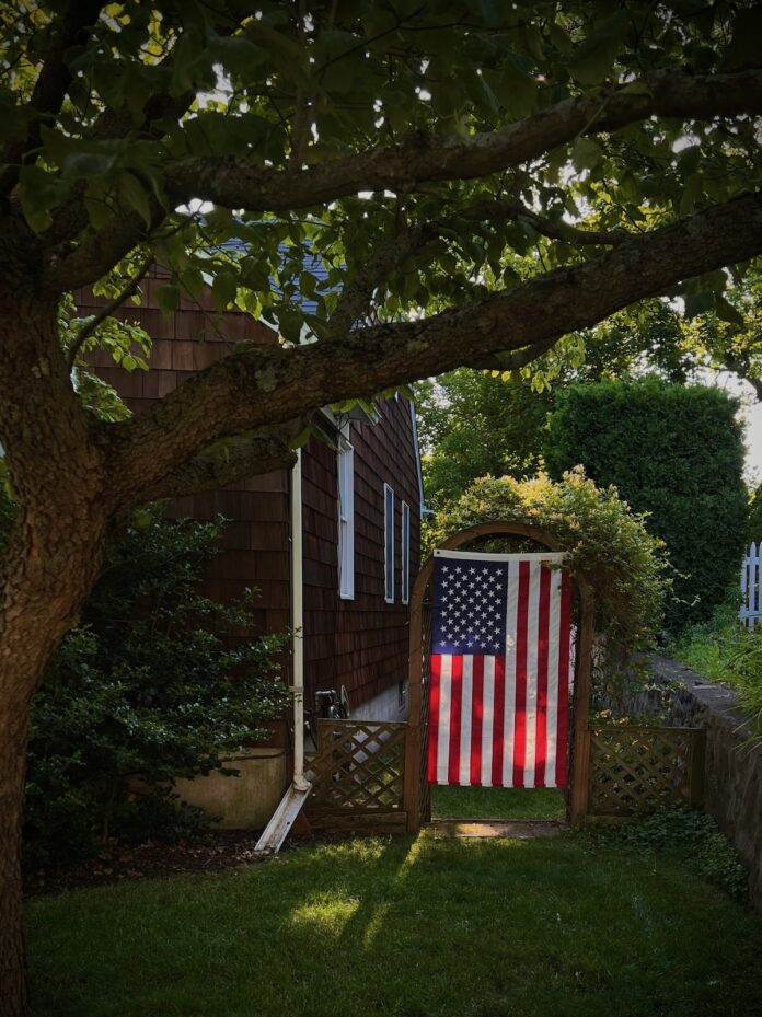 American Flag hanging in a backyard