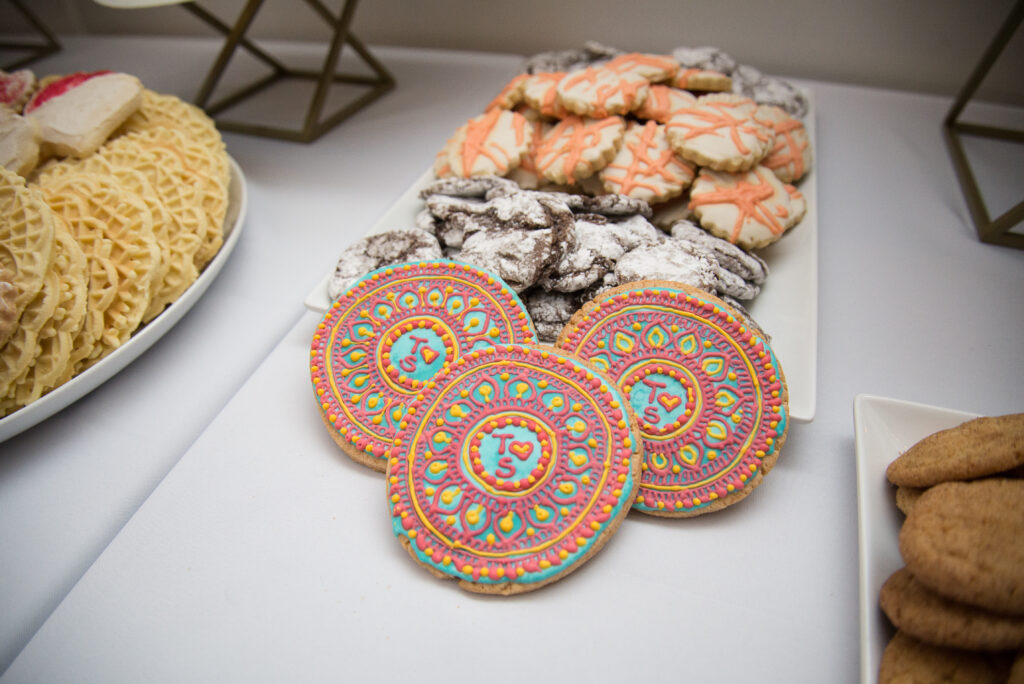 hlad wedding cookie table with orange and blue frosting