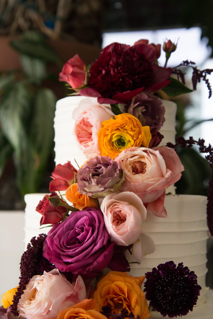 hlad wedding cake white with purple and orange flowers
