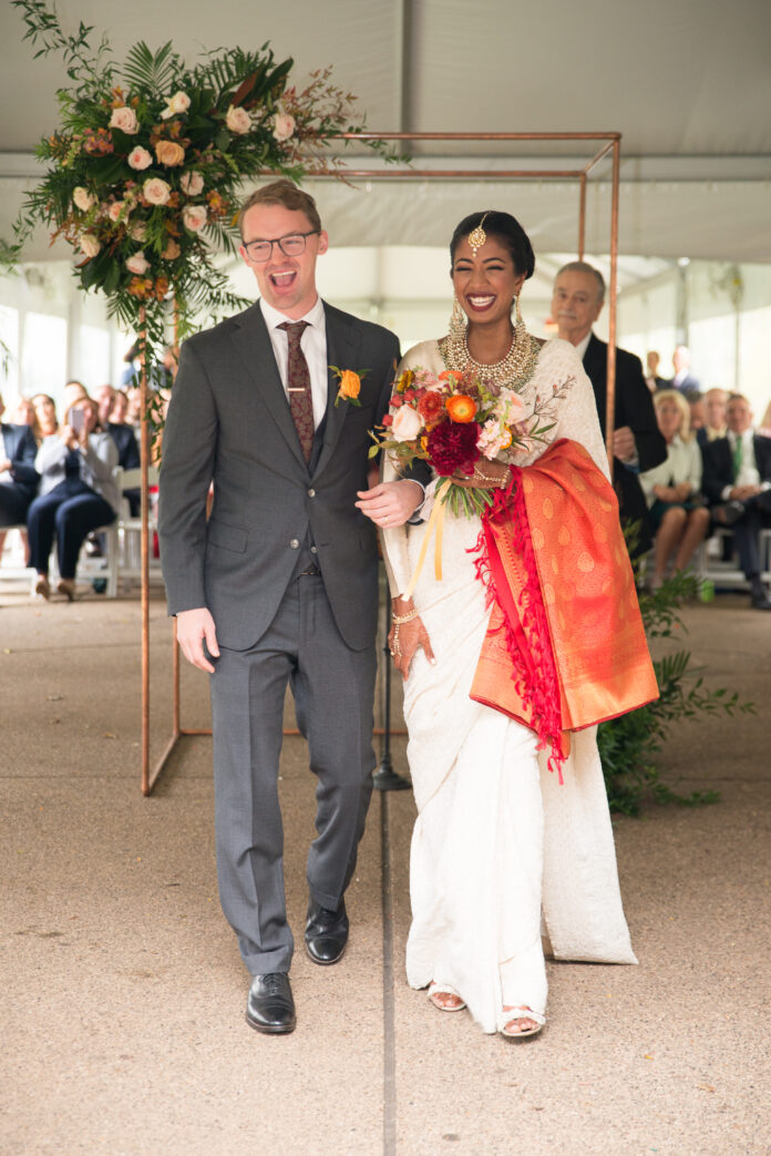 bride and groom standing together facing camera after wedding