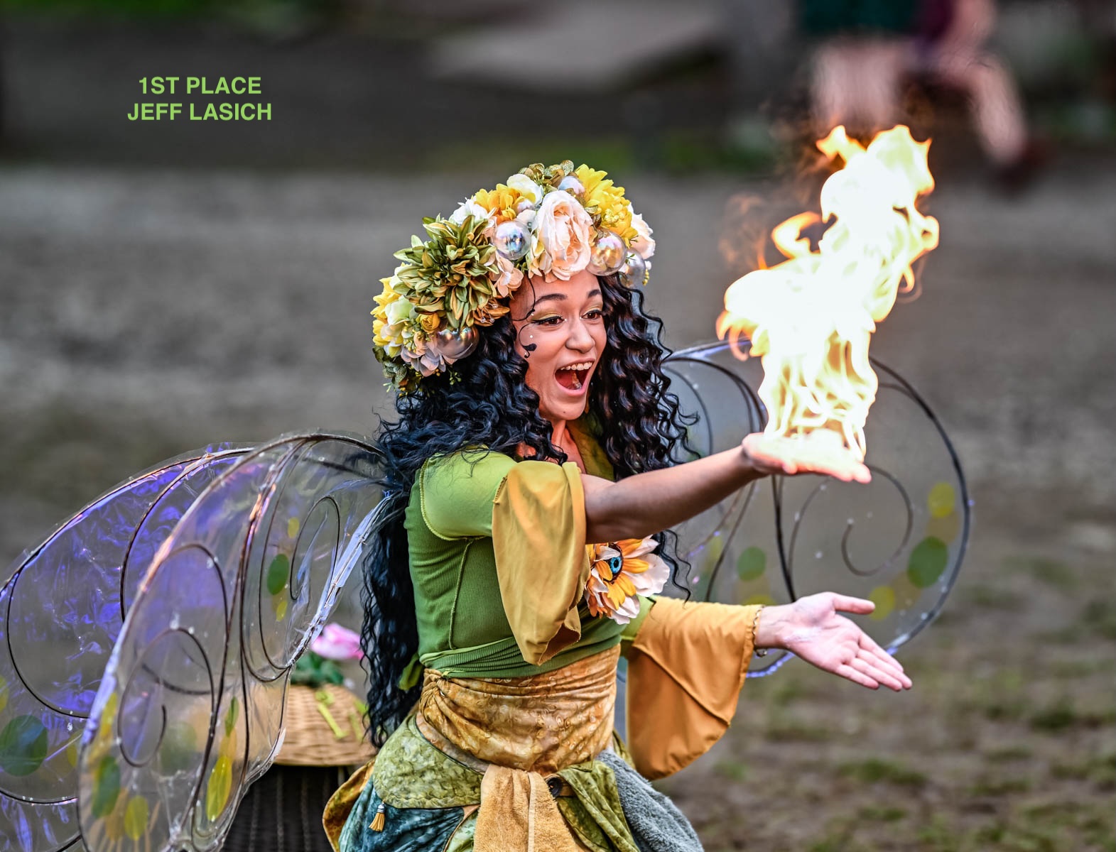 Pittsburgh Renaissance Festival girl holding fire in green costume