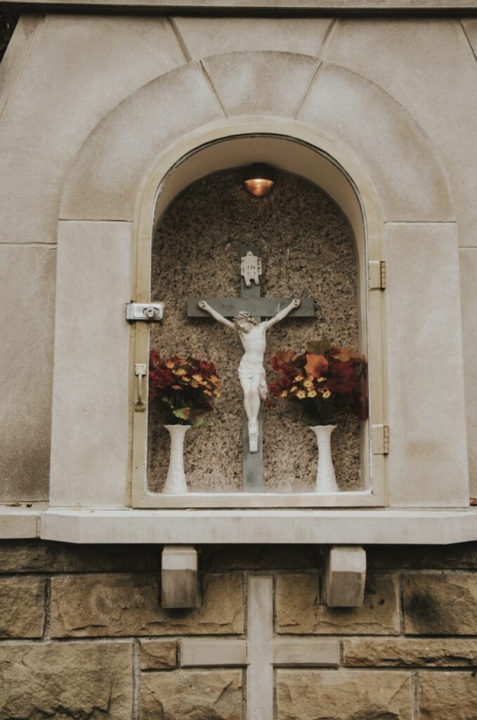 white hanging statue of jesus on cross