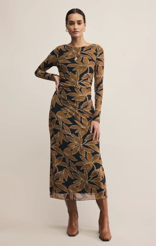A woman in a long brown and black dress.