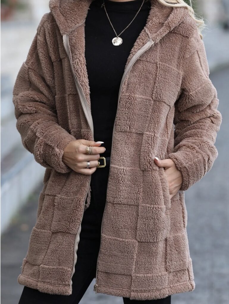 A woman in a plush rose jacket.