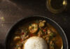 Chef Jackie Page’s Comfort Food Recipes A bowl of hearty stew featuring rice, vegetables, and a medley of seafood, including shrimp and crab meat.