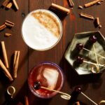 A festive array of beautifully crafted cocktails, featuring unique flavors and garnishes, perfect for celebrating and toasting during the holiday happy hour.