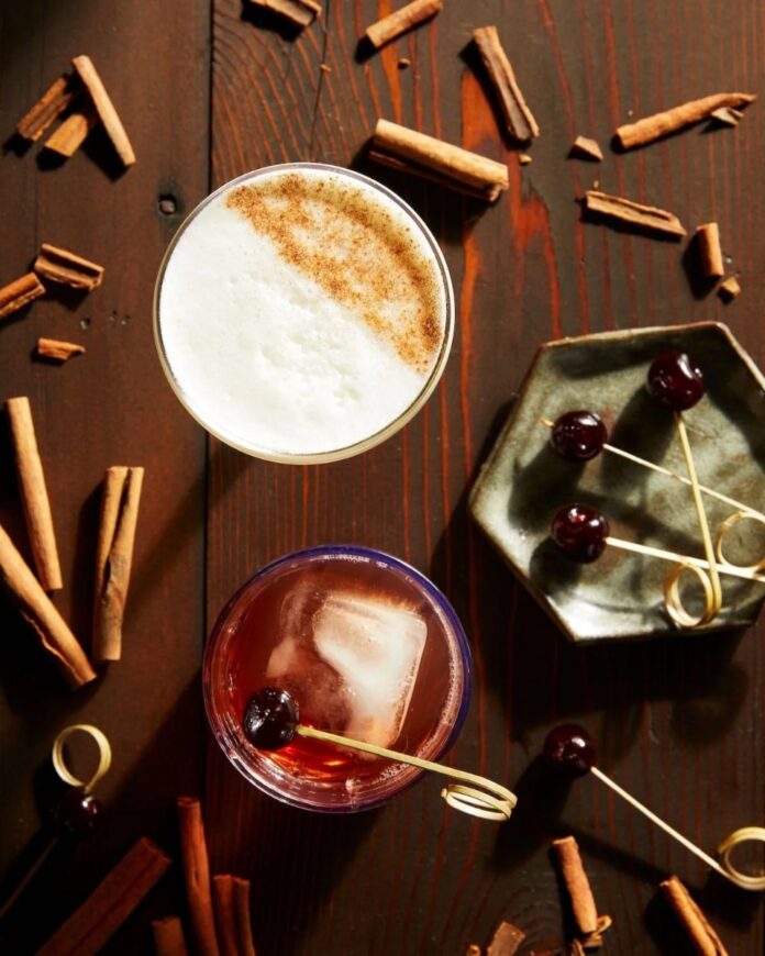 A festive array of beautifully crafted cocktails, featuring unique flavors and garnishes, perfect for celebrating and toasting during the holiday happy hour.