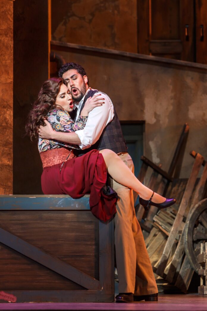 Two performers embrace on stage during a Pittsburgh Opera show.